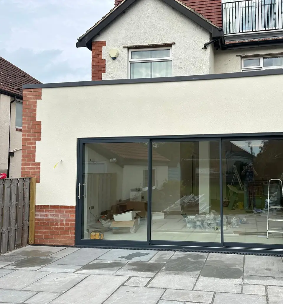 Rear extension finished in a smooth render with large sliding doors