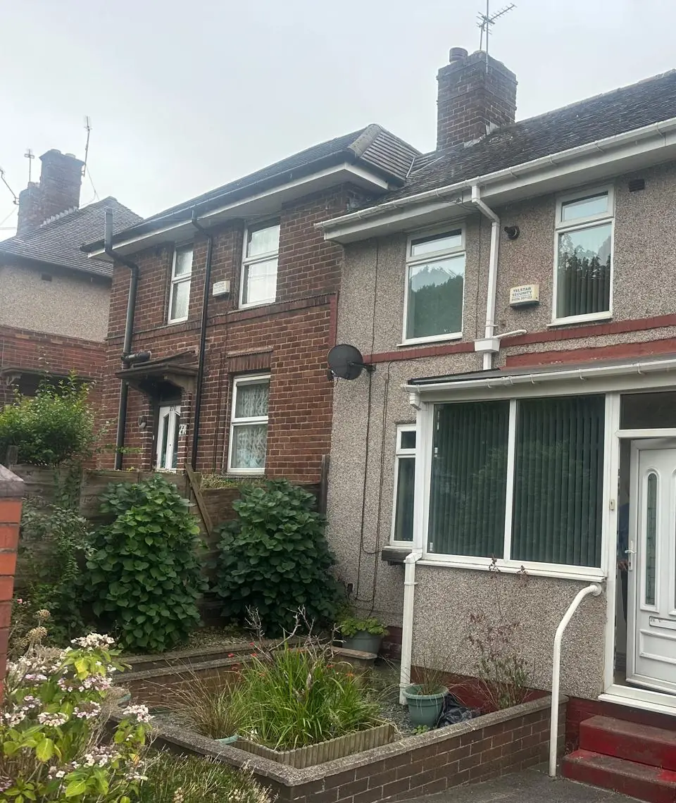 Semi-detached house with old pebbledash before re-rendering